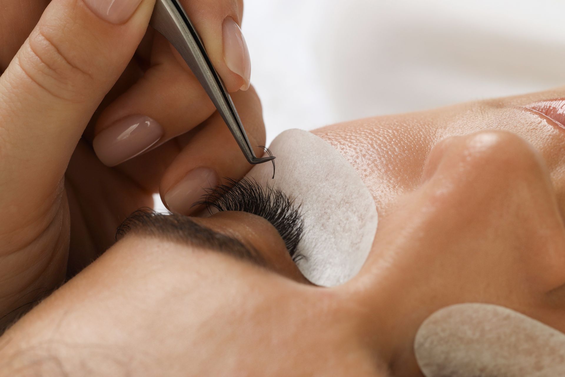 A person receiving eyelash extensions