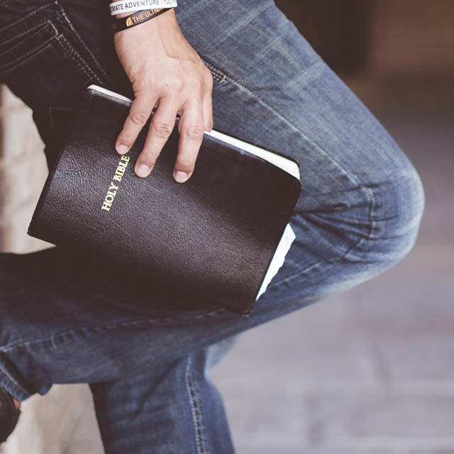A close up of a person playing an acoustic guitar