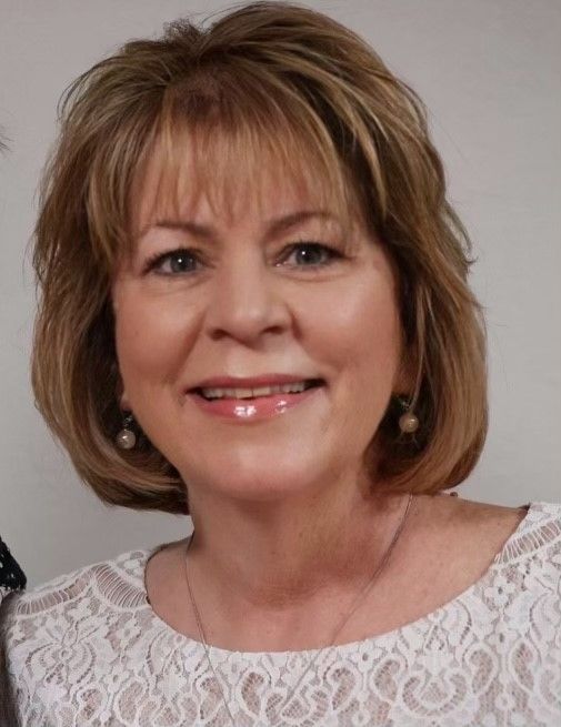 A woman is smiling for the camera.