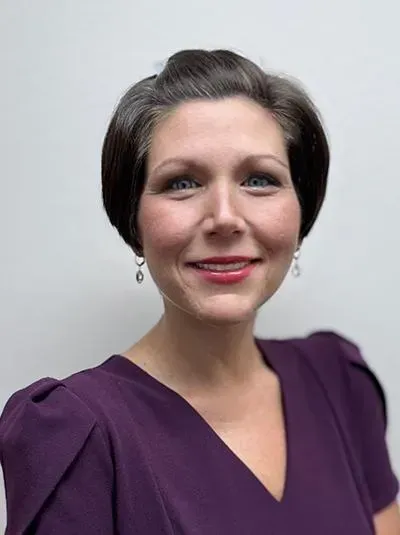 A young woman is smiling for the camera.