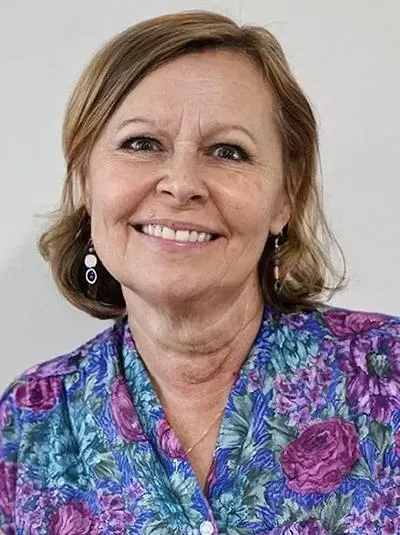 A woman is smiling for the camera.