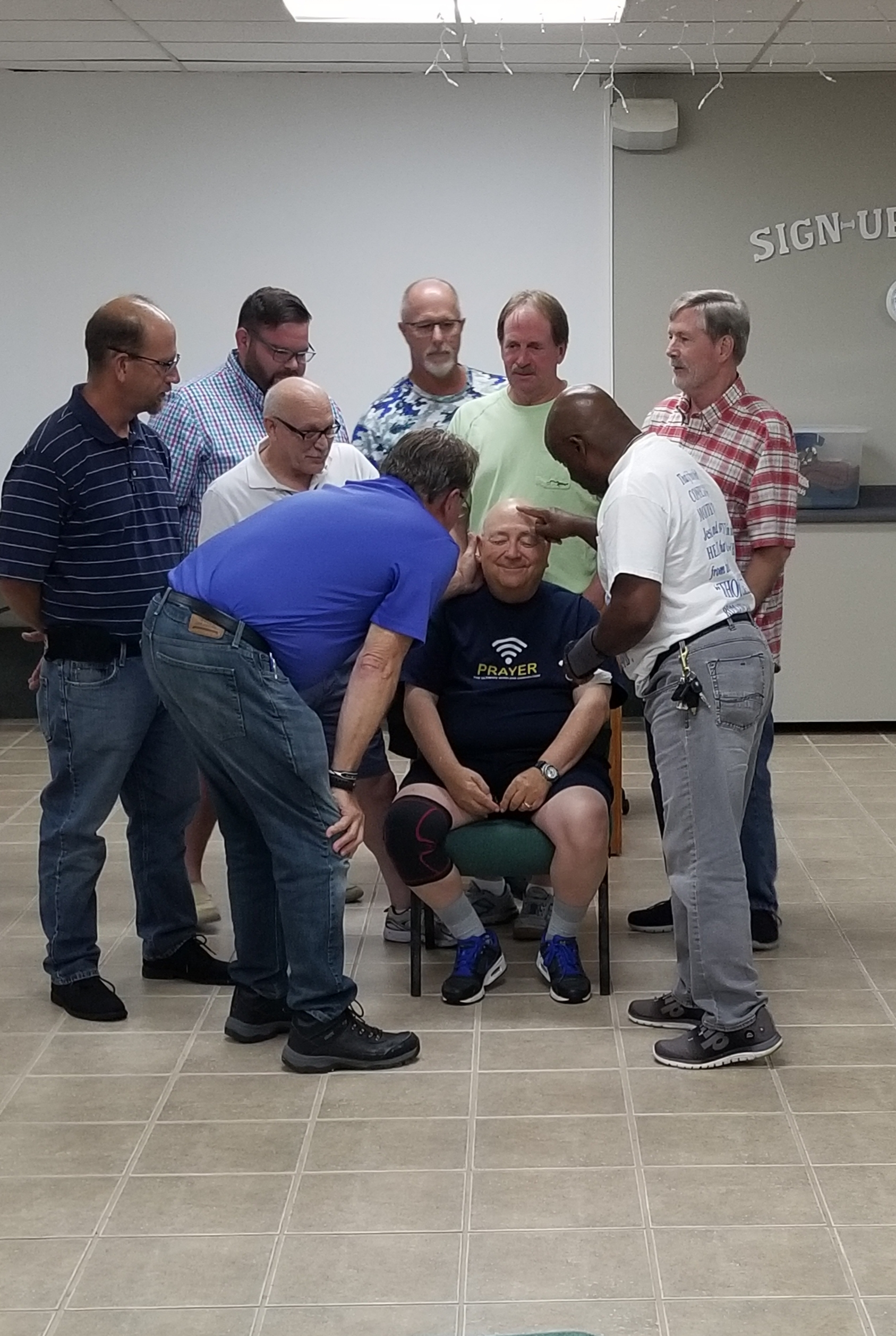 A group of young men are sitting on top of a hill.