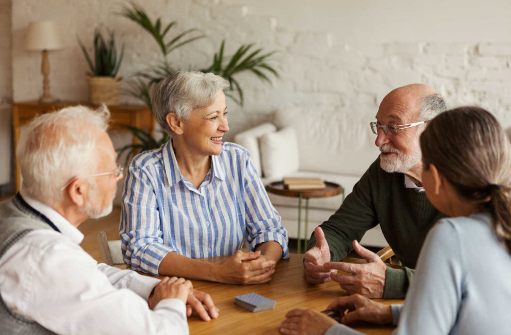 A group of people are putting their hands together in a circle for life groups.
