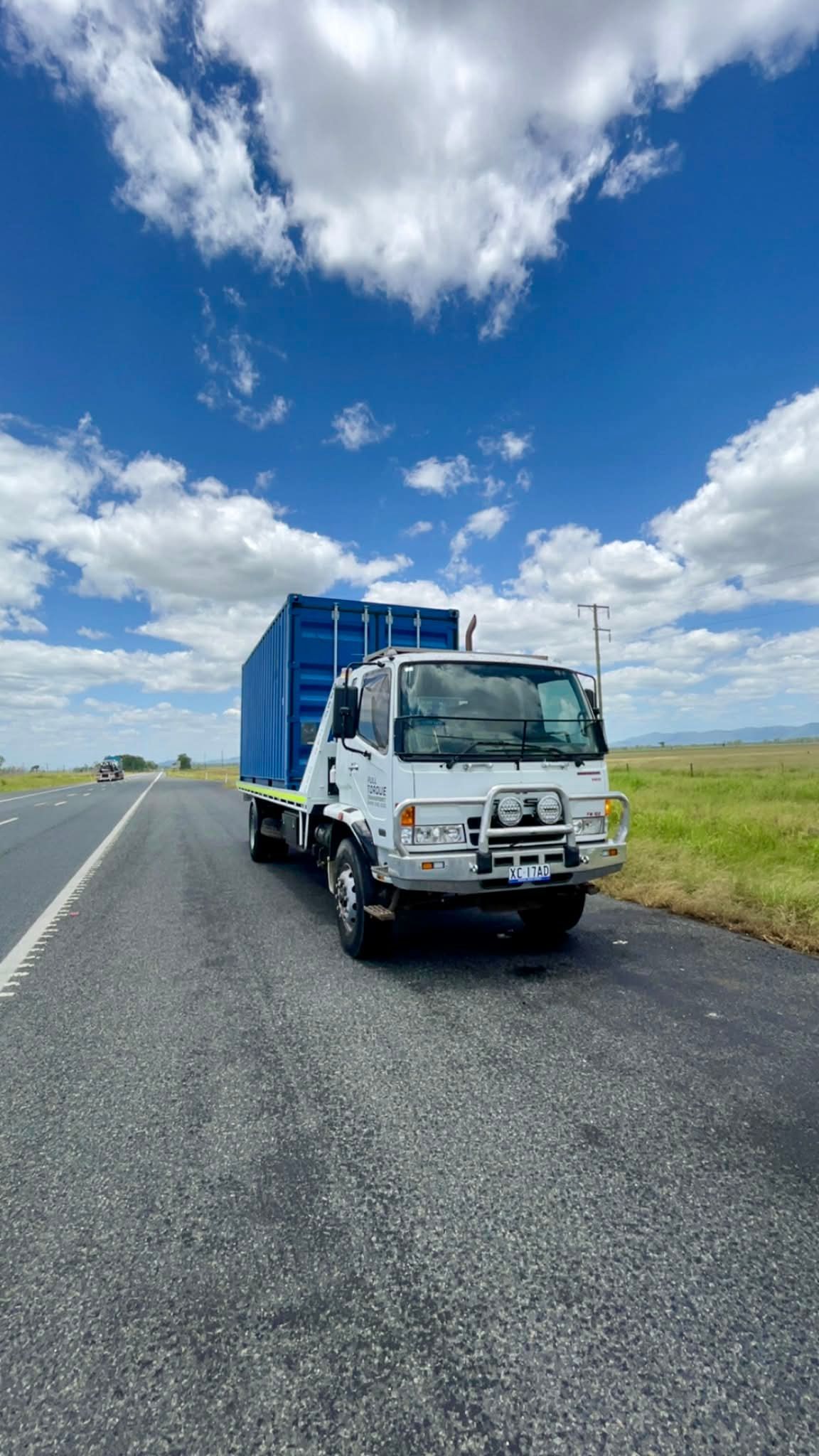 Row of White and Dark Semi-trucks Parked Outdoors, Under a Cloudy Sky — Full Torque Transport In Parkhurst, QLD 