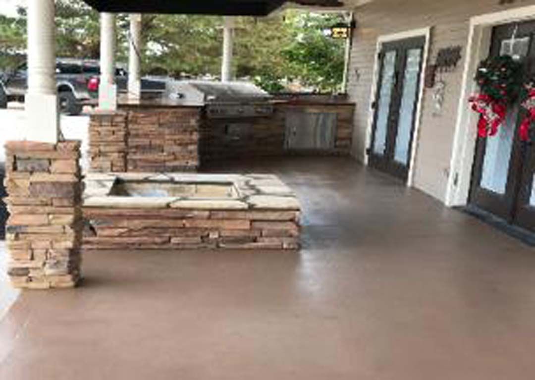 There is a fire pit on the porch of a house.