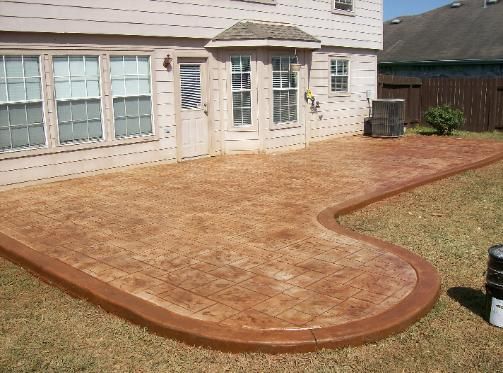 A house with a concrete walkway in front of it