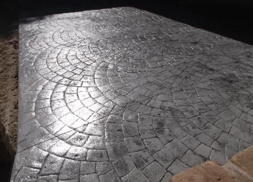 A close up of a concrete floor with a pattern on it.