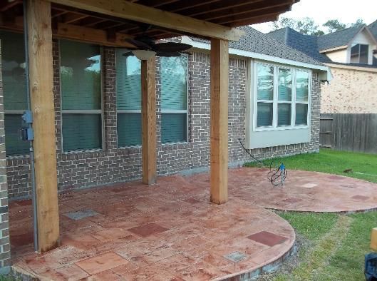 A brick house with a patio in front of it.