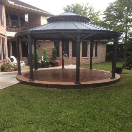 A gazebo in the backyard of a house