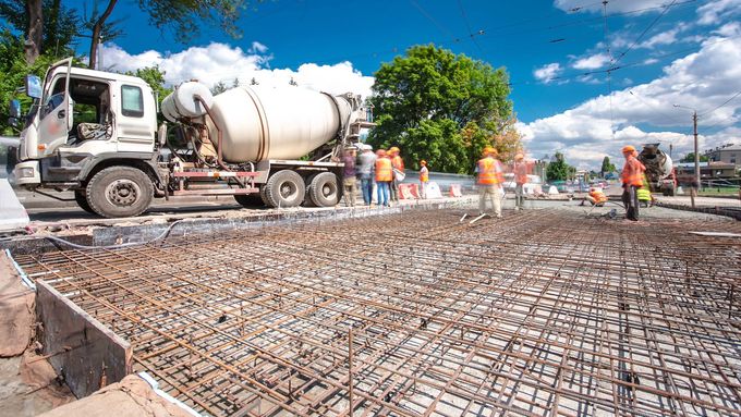 A concrete mixer truck is pouring concrete on a construction site.