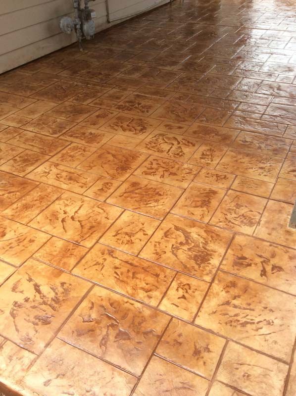 A close up of a concrete floor with a brick pattern.