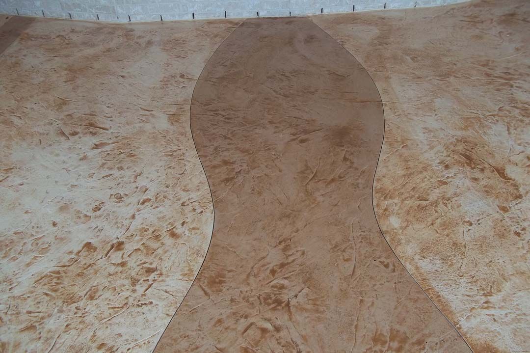 A close up of a marble floor with a swirl pattern.
