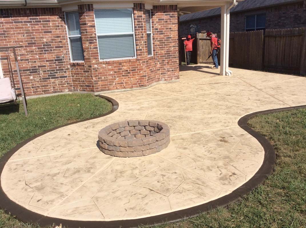 There is a fire pit in the middle of the patio.