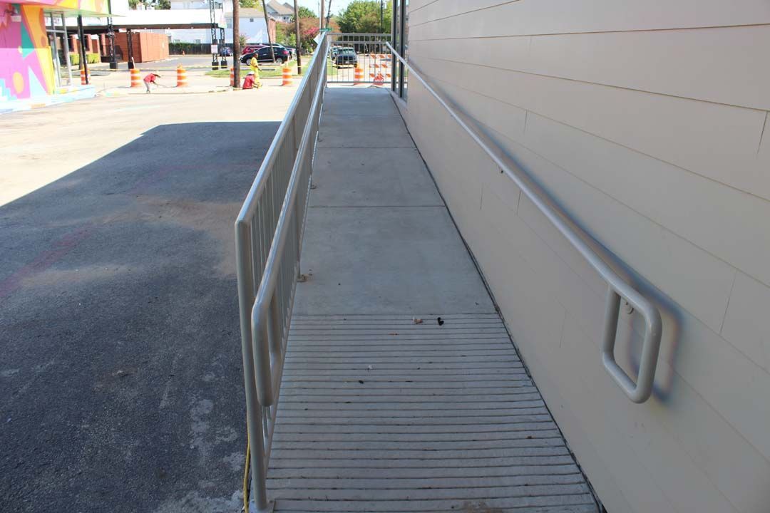A ramp with a railing on the side of a building