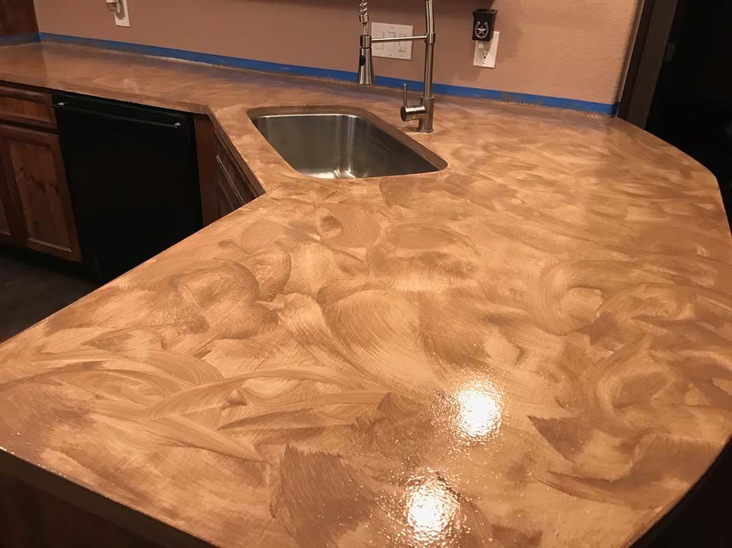 A kitchen counter with a sink and a stainless steel sink.