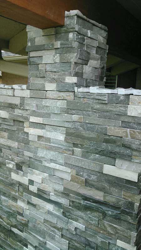 A stone wall with a chimney in the middle of it.