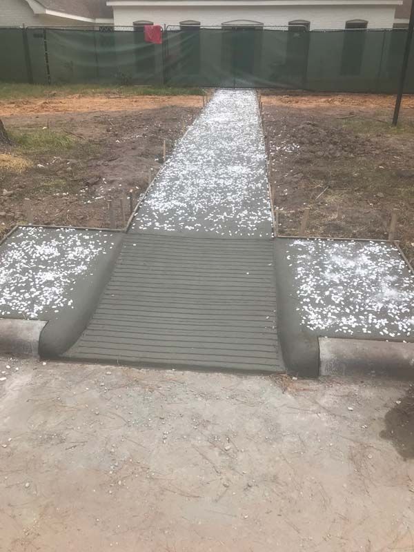 A concrete walkway with a ramp in the middle of it.