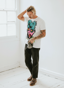 Woman in black crop top and denim shorts, hands on hips, with a cherry graphic on the shirt.