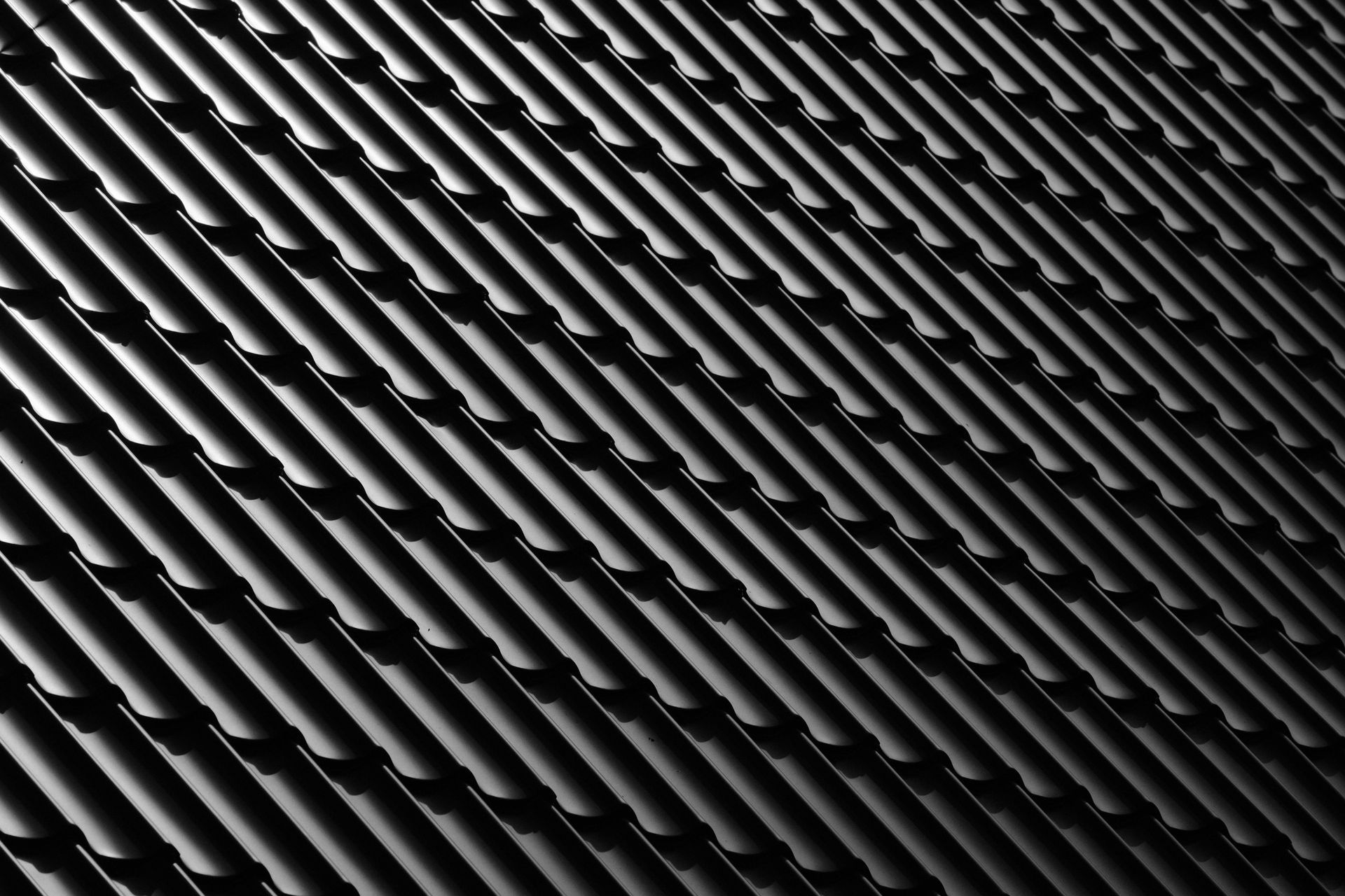 A black and white photo of a roof with a diagonal pattern.