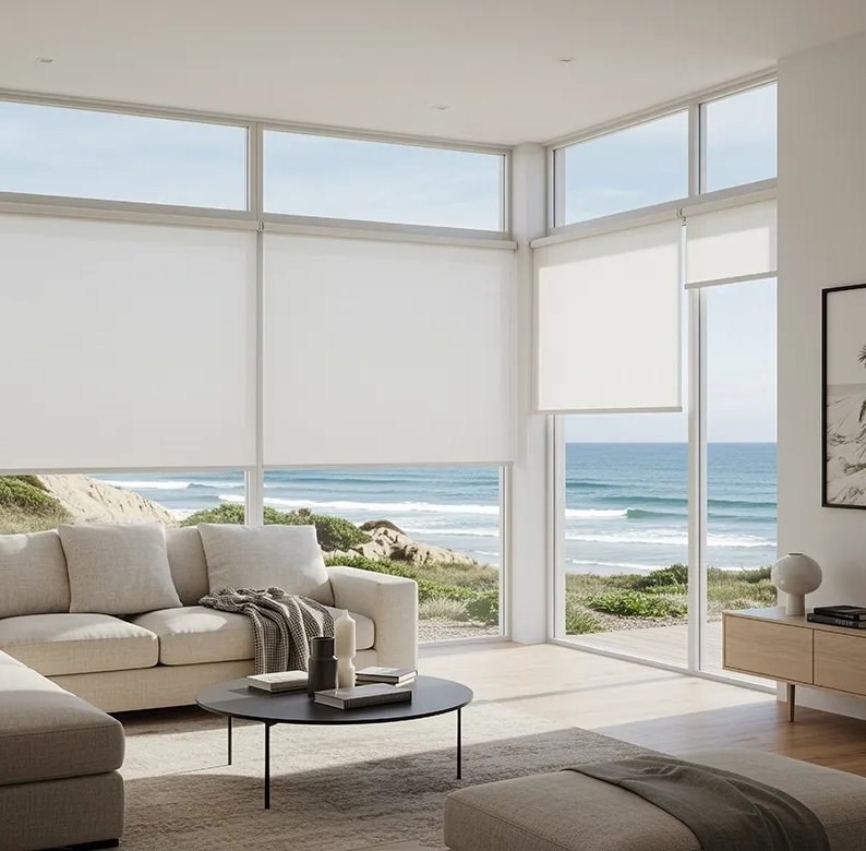 Living room with white roller shades, ocean view, and light-coloured furniture — Proshield Insulation & Waterproofing In Shellharbour, NSW