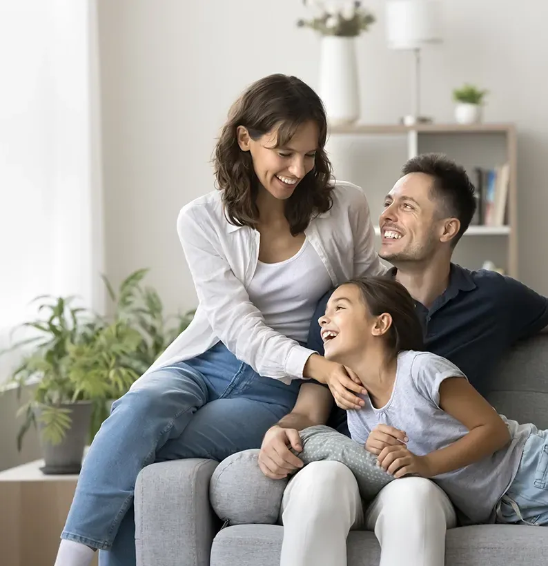 A Family Relaxing on a Lounge — Proshield Insulation & Waterproofing In Campbelltown, NSW