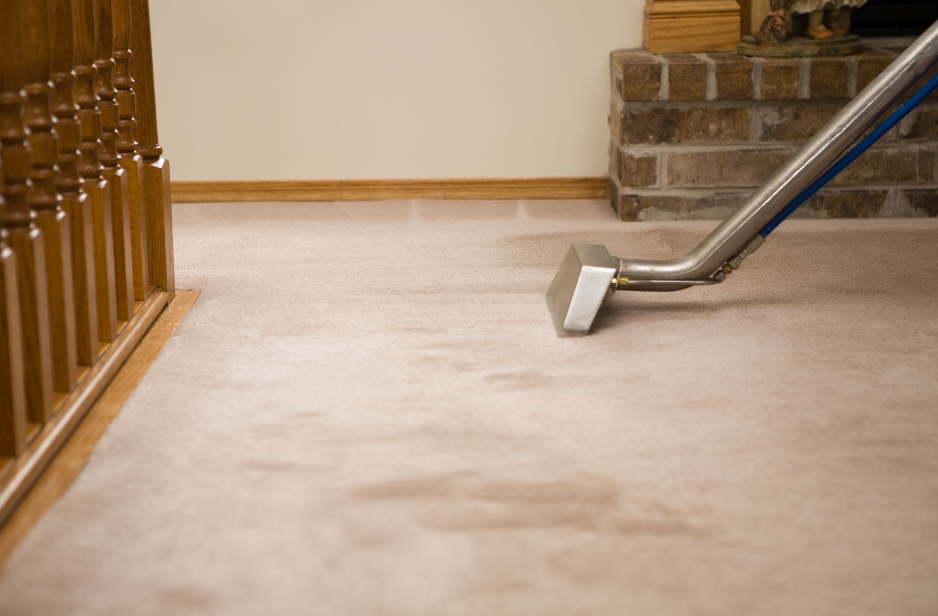 A vacuum cleaner is cleaning a carpet in a living room. — Durant, OK — James Dry Carpet & Upholstery Cleaning Service