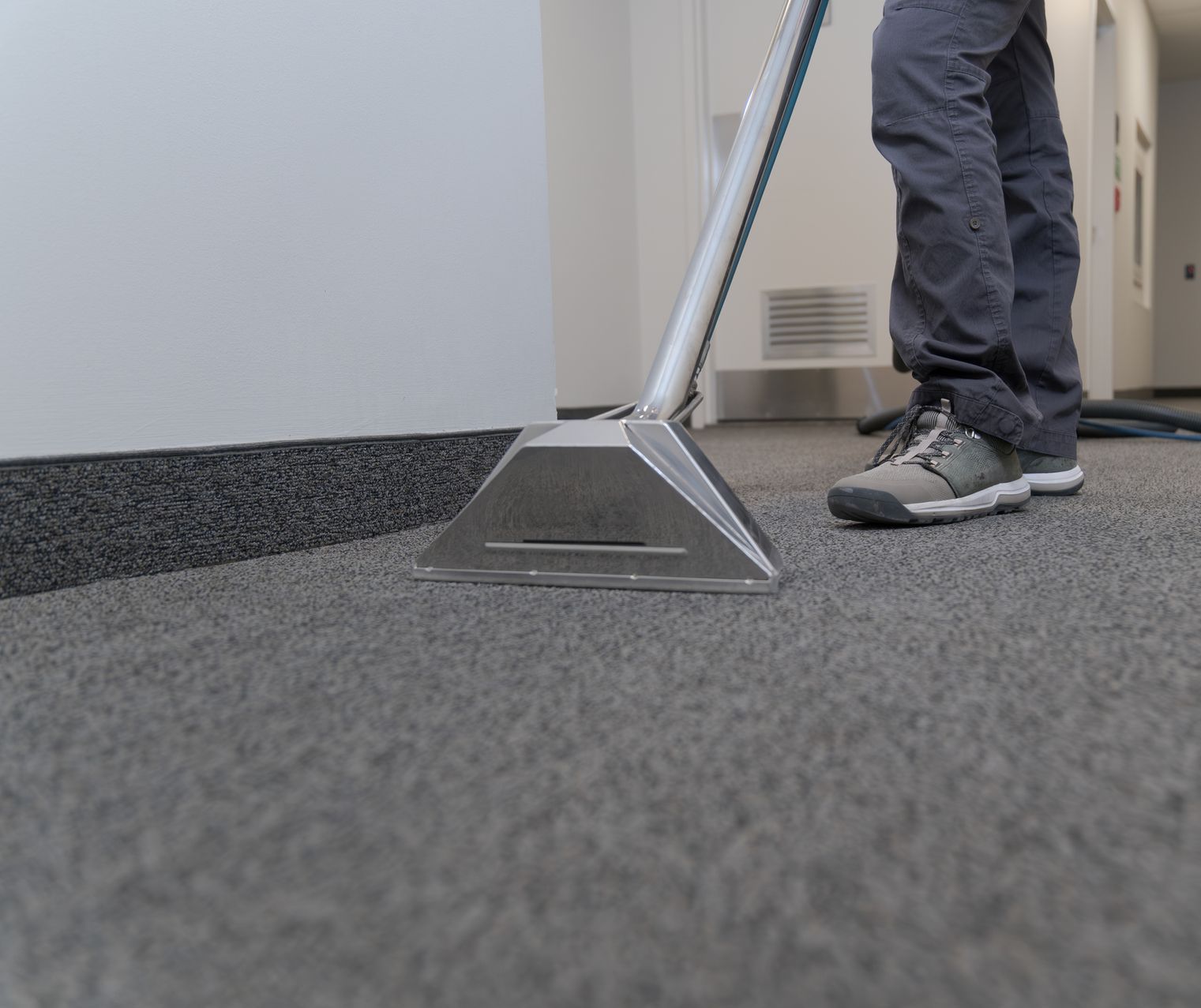 A person is cleaning a carpet with a vacuum cleaner. — Durant, OK — James Dry Carpet & Upholstery Cleaning Service A person is cleaning a carpet with a vacuum cleaner. — Durant, OK — James Dry Carpet & Upholstery Cleaning Service