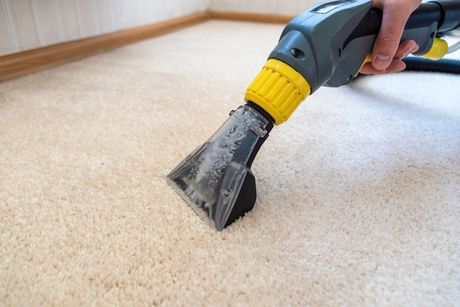 A person is cleaning a carpet with a vacuum cleaner. — Durant, OK — James Dry Carpet & Upholstery Cleaning Service A person is cleaning a carpet with a vacuum cleaner. — Durant, OK — James Dry Carpet & Upholstery Cleaning Service
