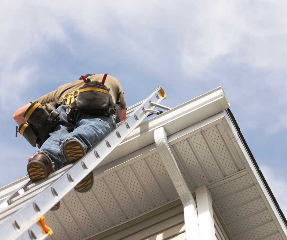 A man is climbing a ladder on the side of a house