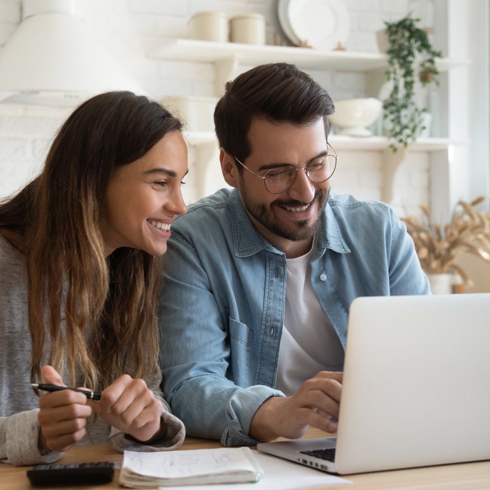 A Happy Couple Browsing on a Laptop A Happy Couple Browsing on a Laptop