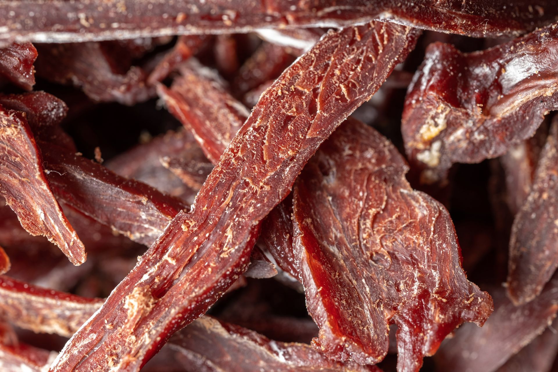 Close-up of thin strips of dried beef jerky showing texture and moisture reduction