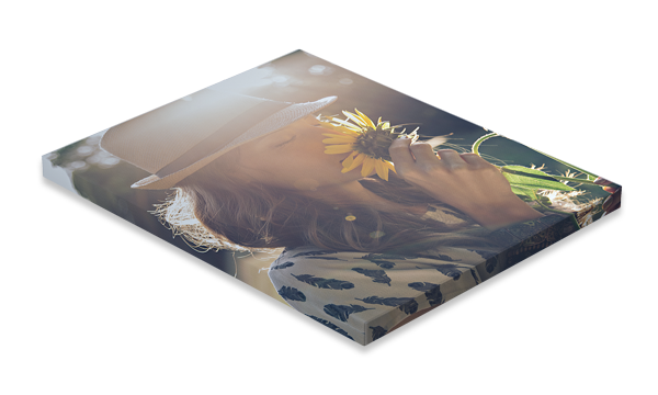 Canvas print of person holding sunflower. Soft lighting, blurred background.