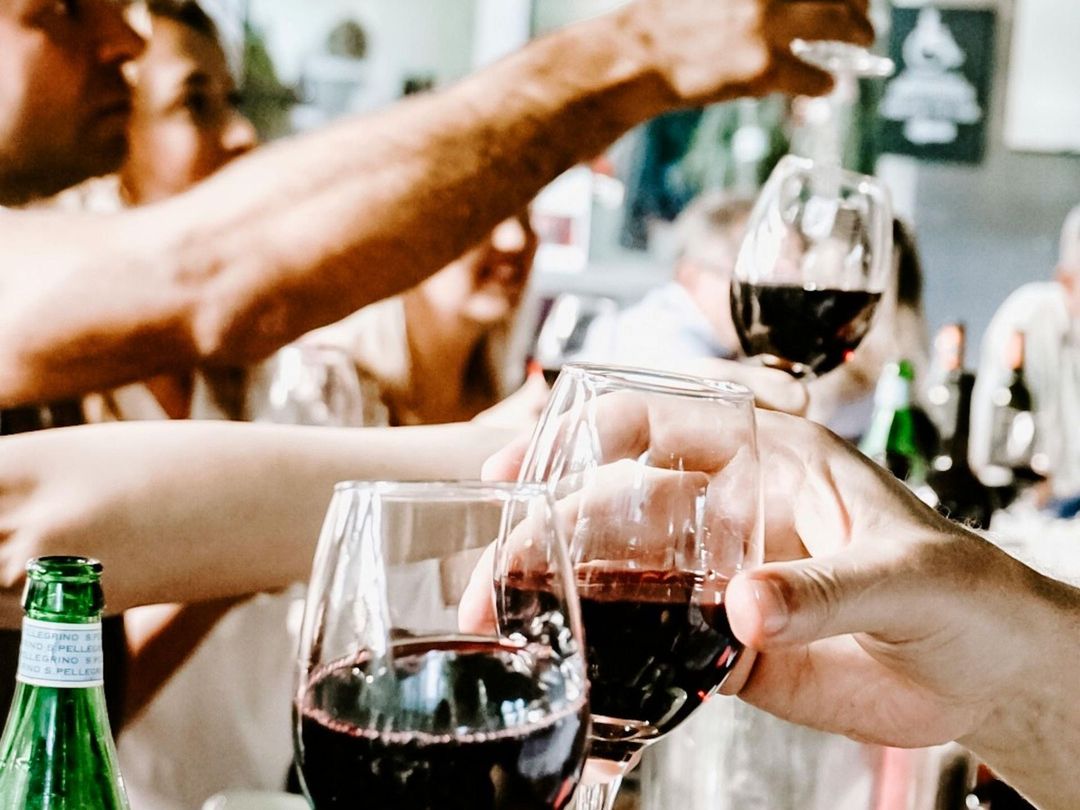 A group of people are toasting with wine glasses.