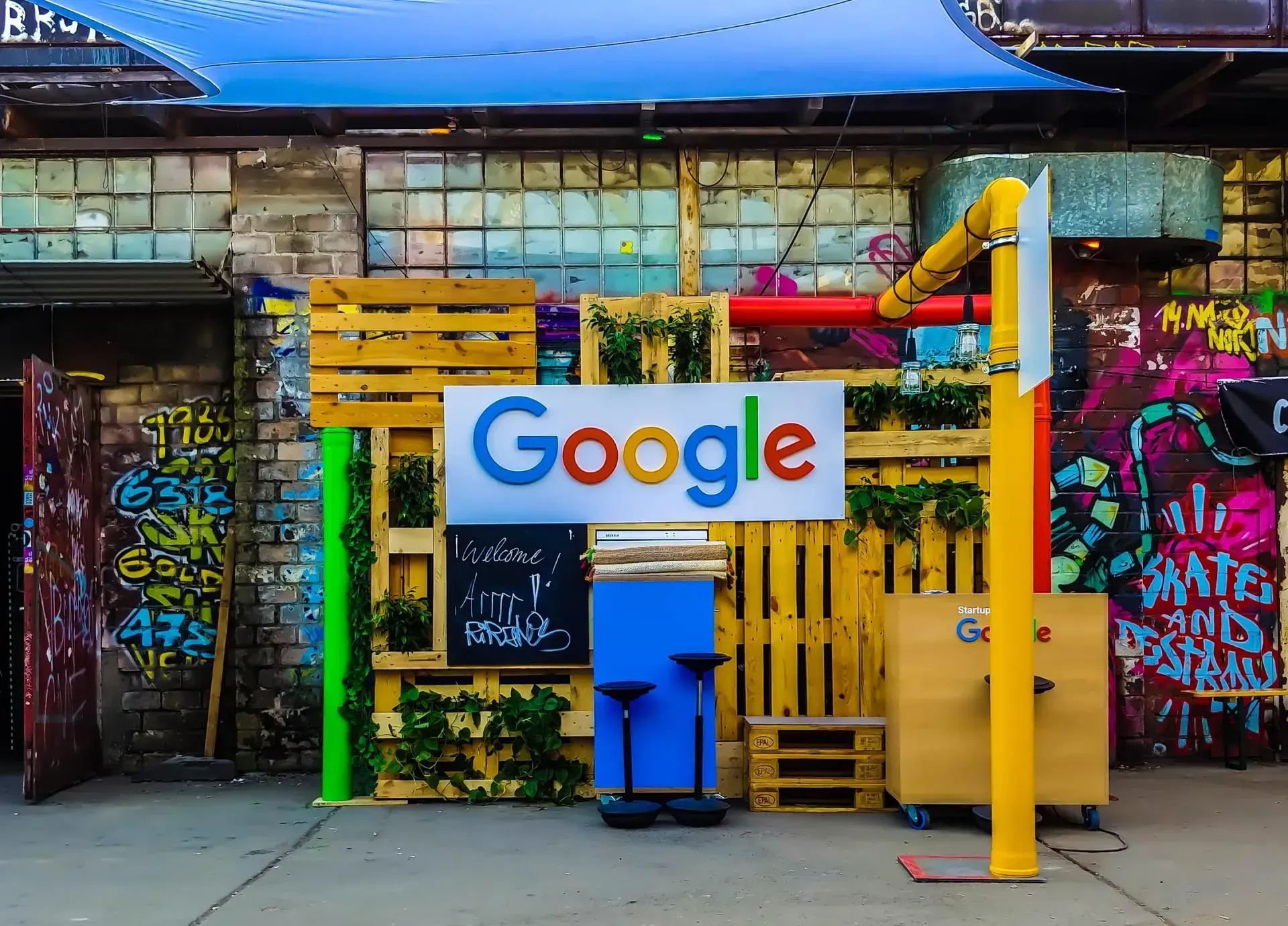 A google sign is on a wooden wall in front of a building.
