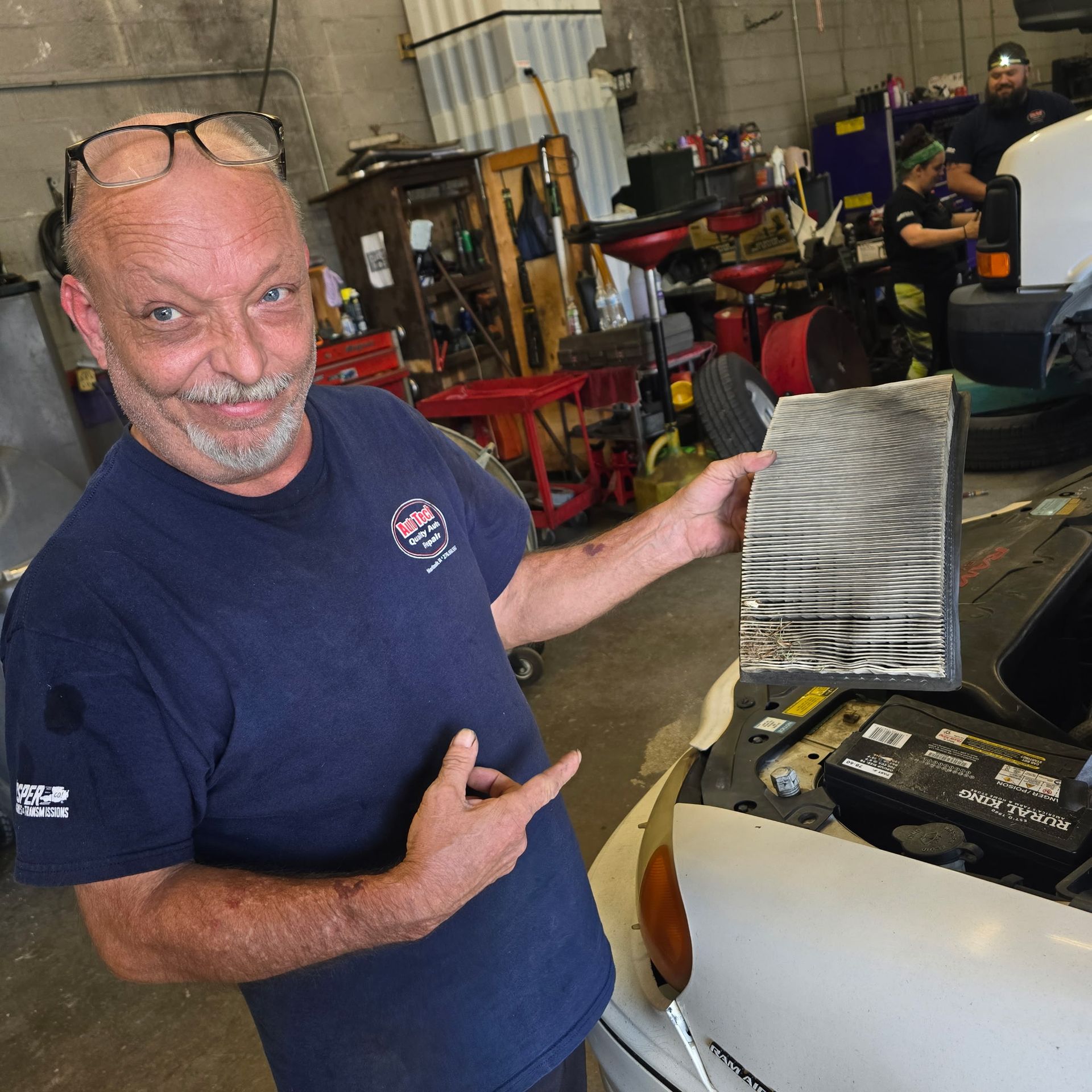 Technician showing a dirty cabin air filter that needs replacement