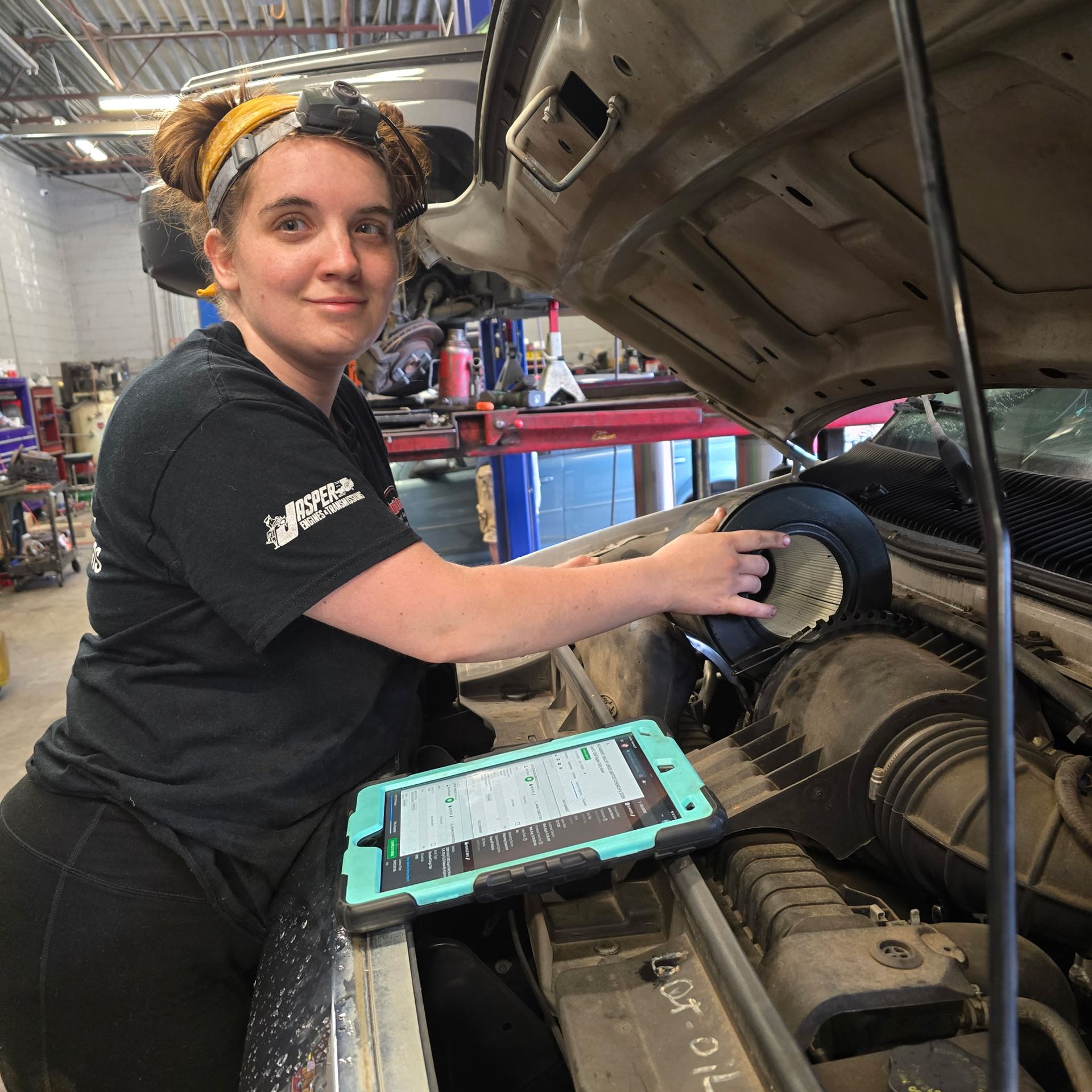 Auto Tech technician replacing a dirty car air filter with a new one during maintenance service in Collinsville, VA;