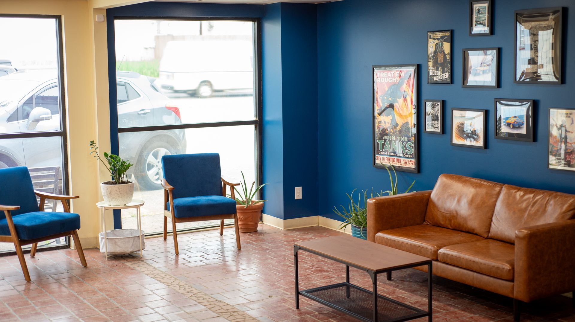 A living room with a couch , chairs , and a coffee table.