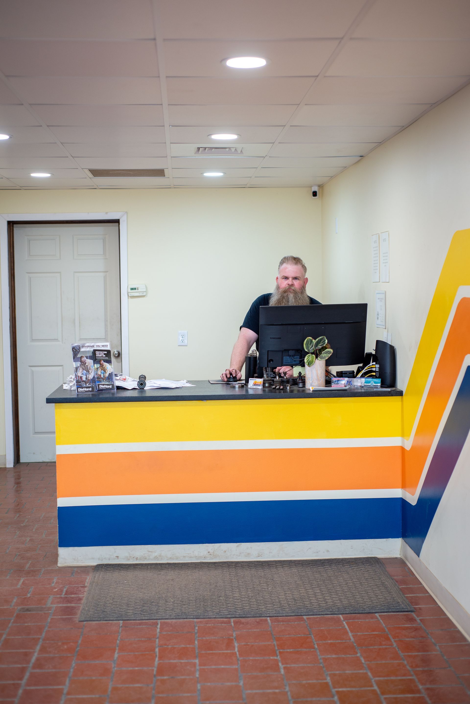 A man is sitting at a desk in front of a computer.