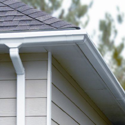 A close up of a gutter on the side of a house