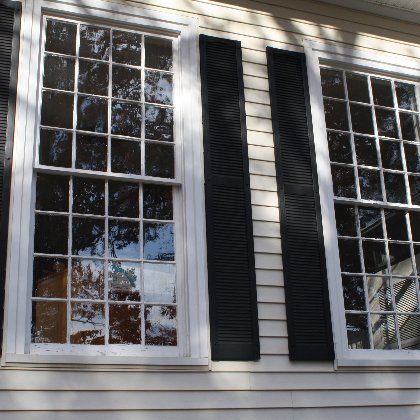 A white house with black shutters on the windows