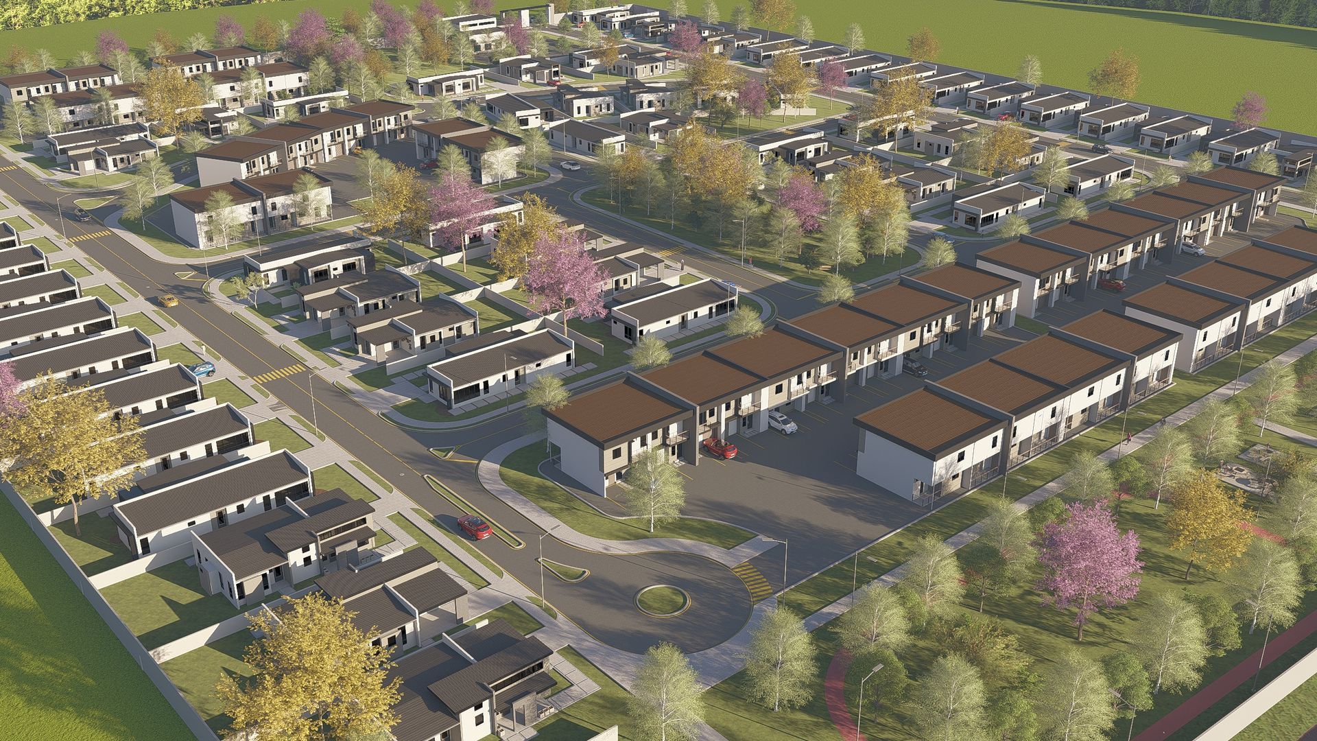 Aerial view of a planned residential neighborhood with rows of houses, roads, and trees in an autumn setting.