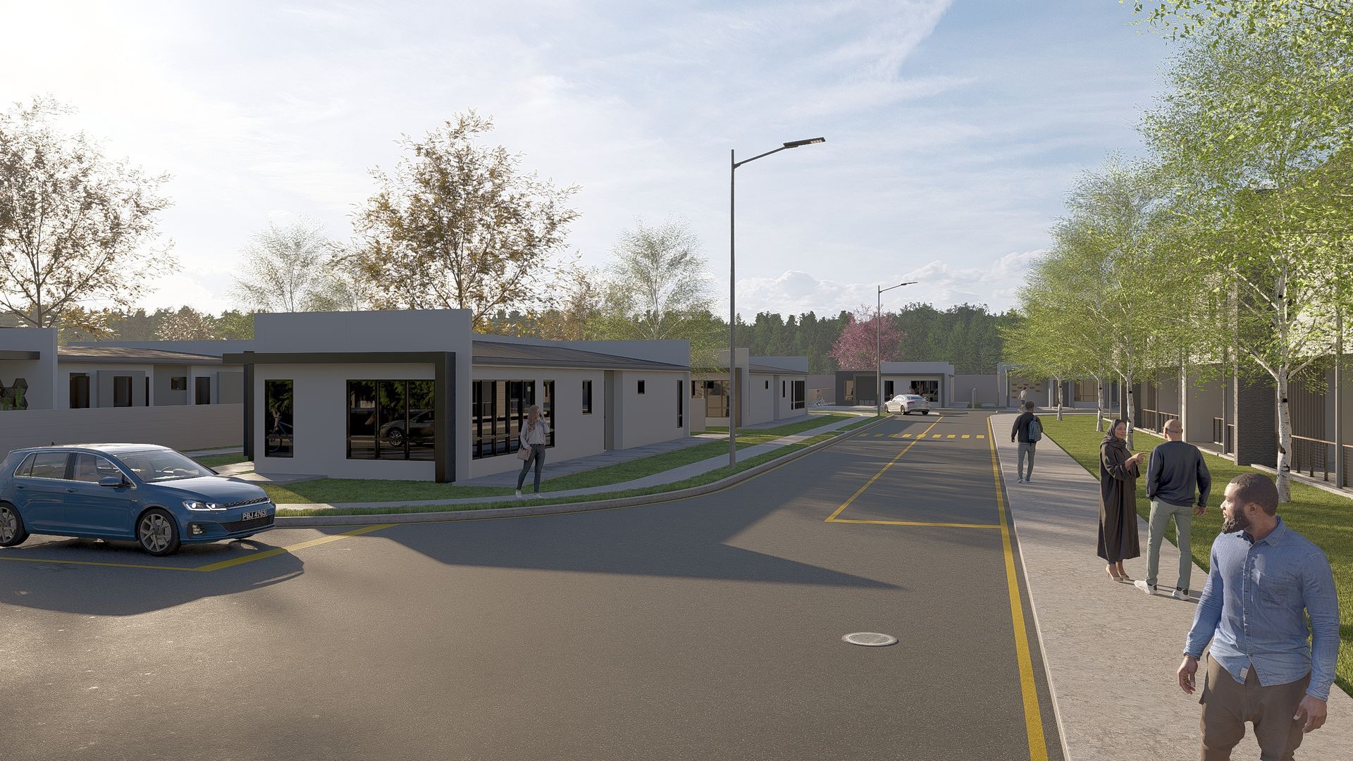 Street scene with buildings, cars, and people walking on the sidewalk. Trees line the road and buildings.