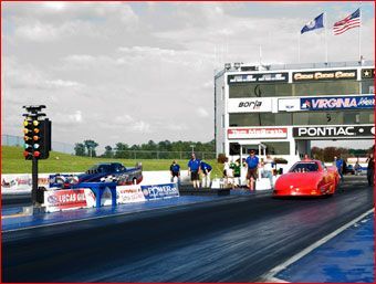 A race track with a pontiac sign in the background