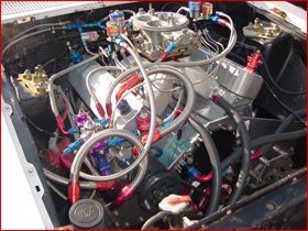 A car engine with a lot of wires coming out of it