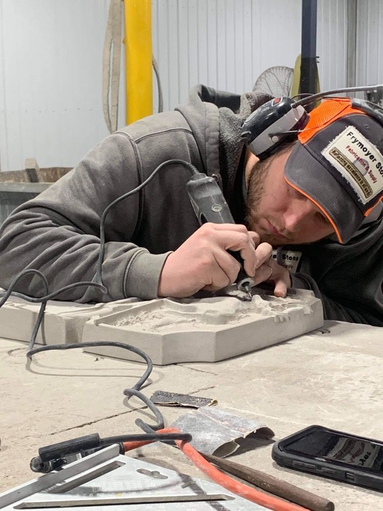 A man wearing headphones is working on a machine