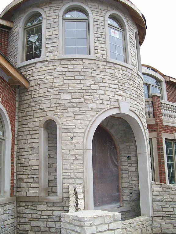 A large brick house with a tower on top of it.