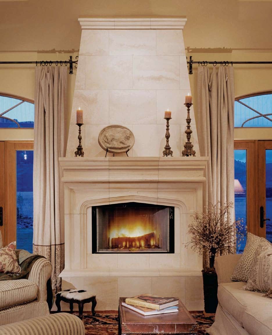 A fireplace with a mantle and candles in a living room.