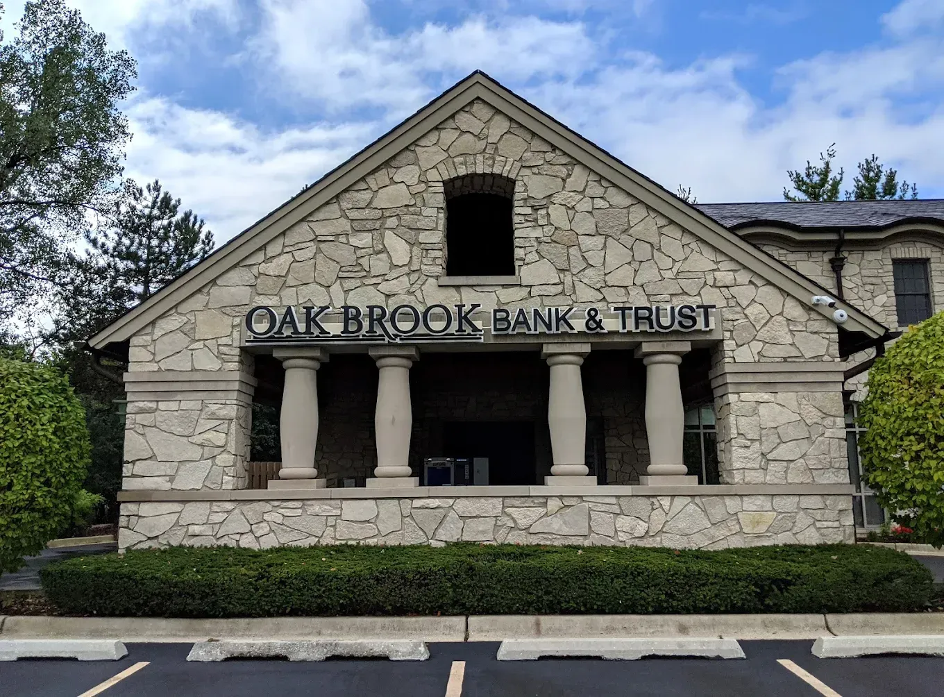 Oak Brook Bank & Trust building with stone facade, columns, and signage.