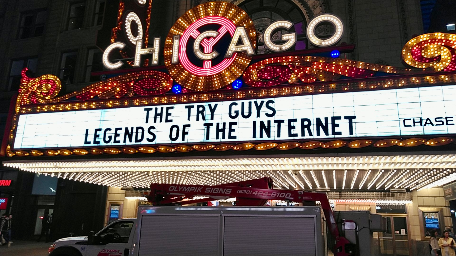 The Chicago Theatre marquee displays "THE TRY GUYS: LEGENDS OF THE INTERNET". A service truck is parked below.