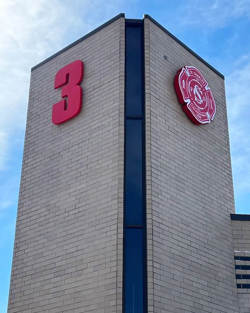 Brick building with a large red 